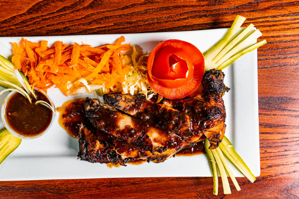 Jerk chicken flame-grilled on the lava rock grill at Island Grill & Pub, Rock Hill SC