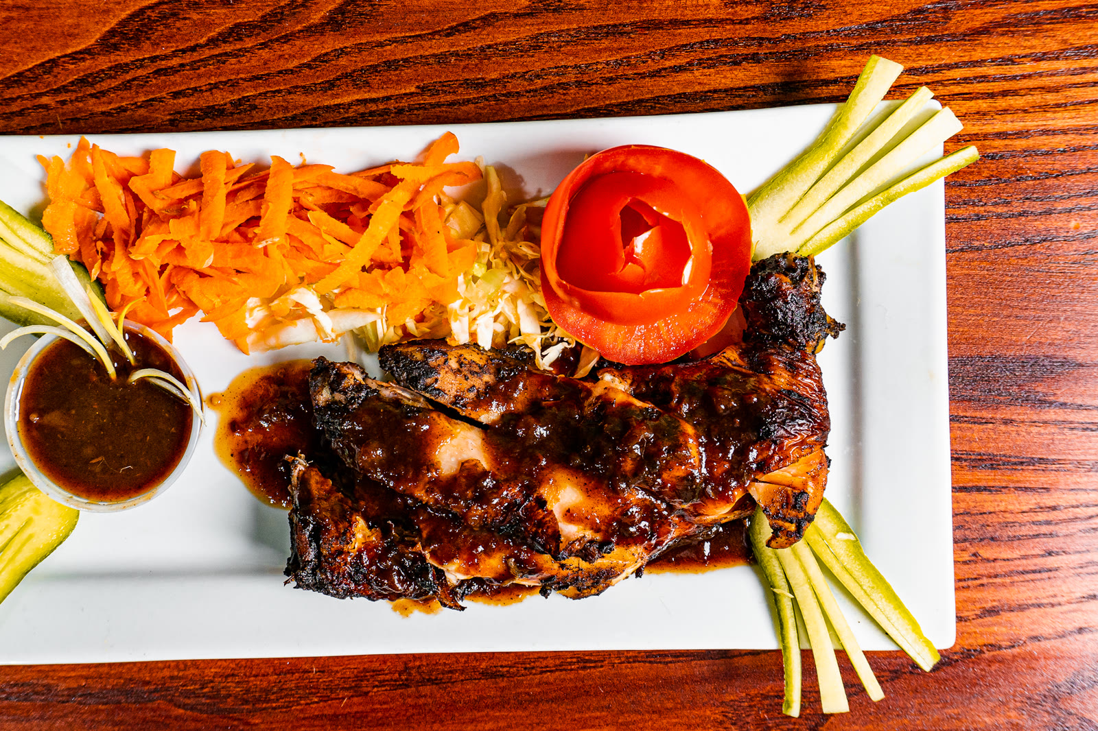 Jerk chicken flame-grilled on the lava rock grill